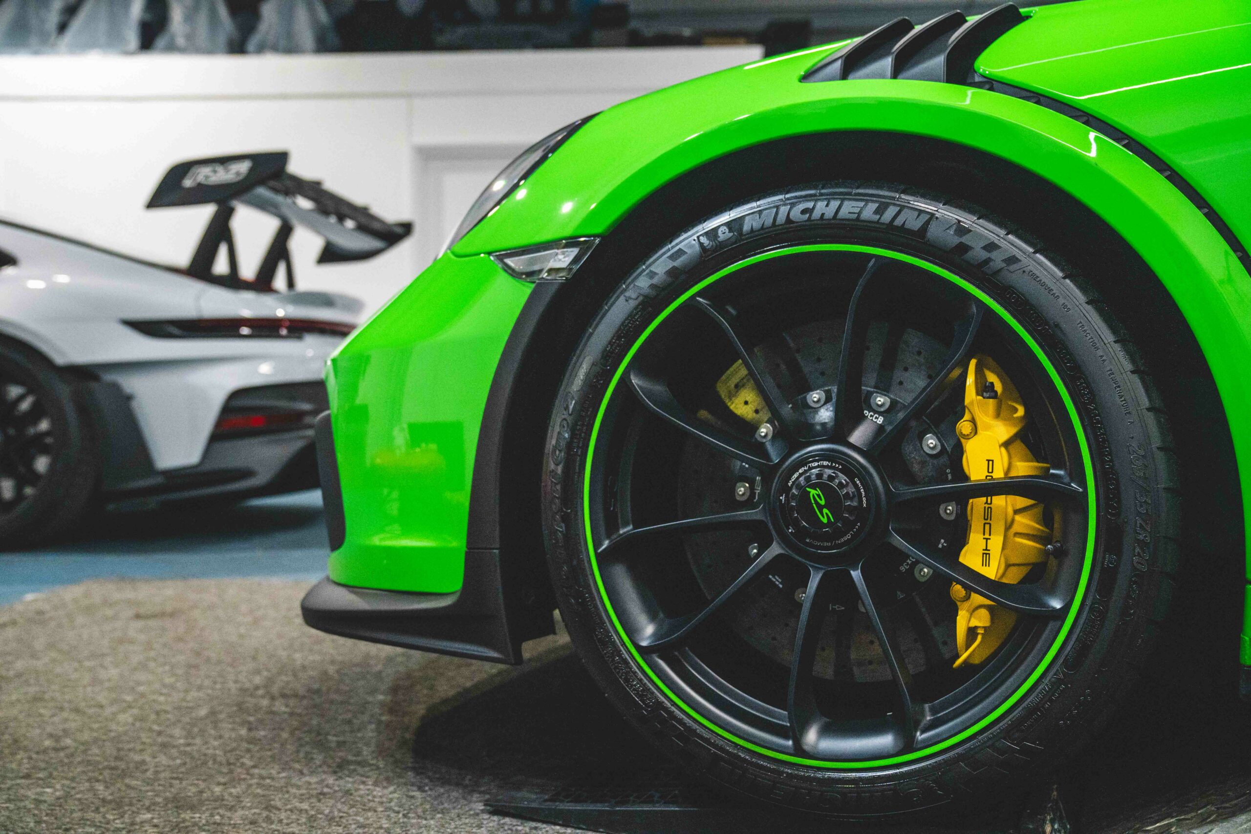 green porsche focused on tyres