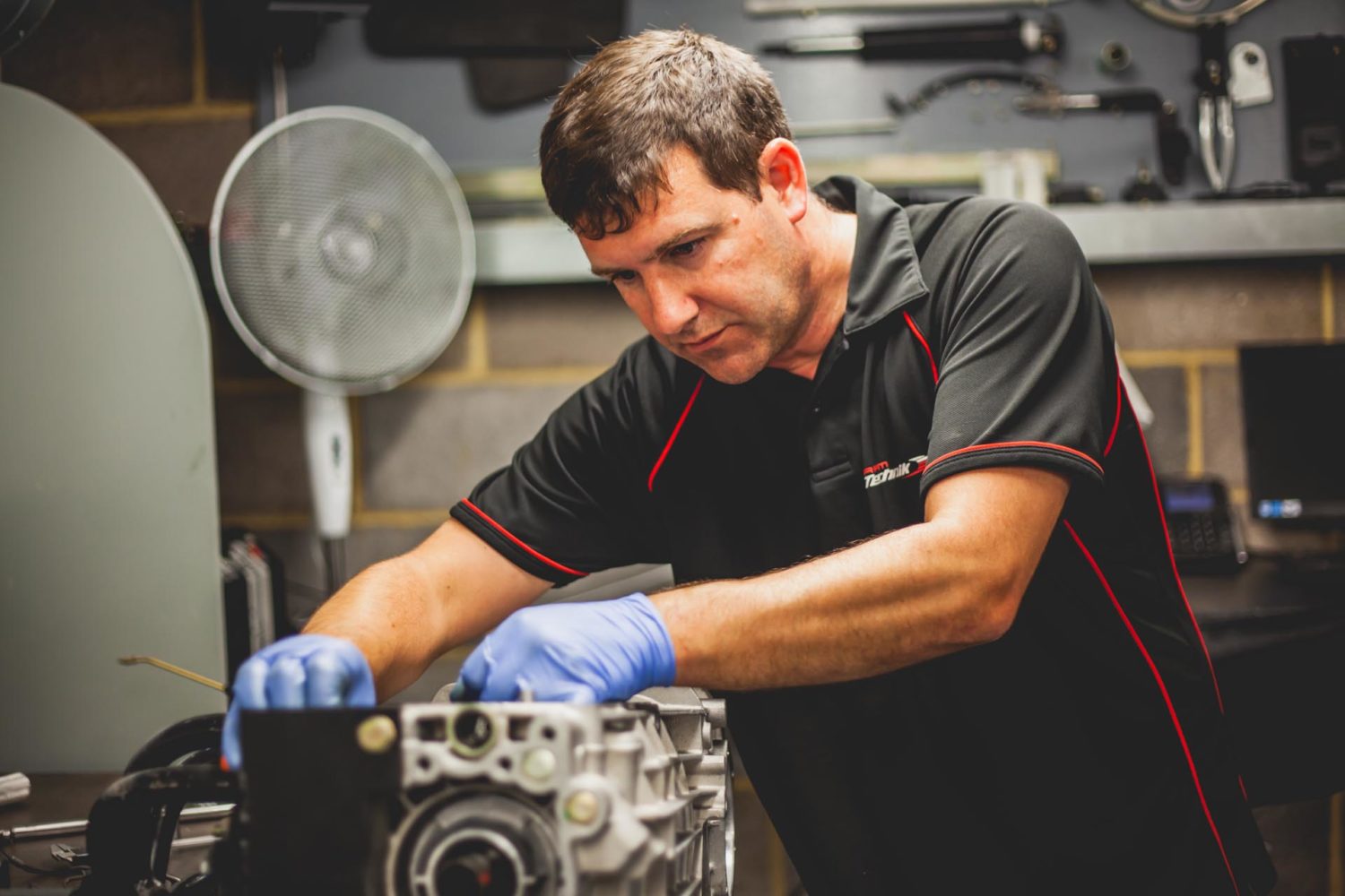 technician building porsche engine